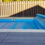 image of a blue solar blanket covering a pool | 3 Ways A Solar Blanket Will Save You Money