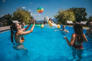 People playing pool volleyball with no net at a distance