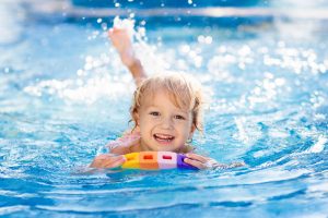 Young child swimming in pool