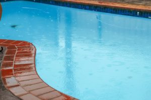 A photo of a pool in the rain.